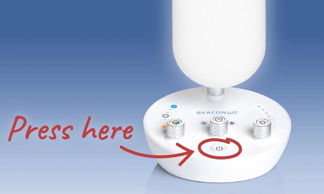 BEACON40 Personal light with a red arrow pointing to its power button and the words Press here.
